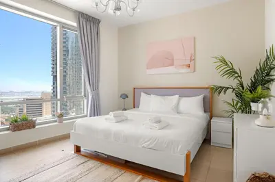 a bedroom with a bed and a large window at VayK - Inviting 1BR in Dubai Marina with Stunning Views in Dubai