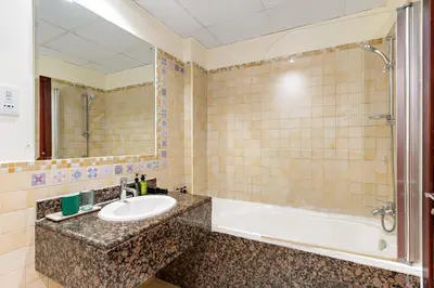 a bathroom with a sink and a shower at VayK - Light-Filled and Spacious 1BR in JBR in Dubai