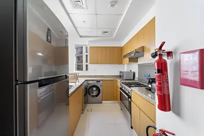 a kitchen with a red fire hydrant hanging from the ceiling at VayK - Generous 2BR Offering Burj Khalifa Views in Dubai
