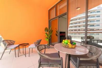 a dining room with a table and chairs at VayK - Chic Studio in Silicon Oasis with Pool View in Dubai