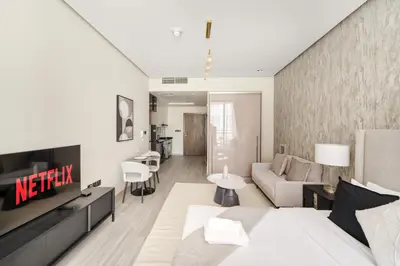 a living room with a bed and a couch at VayK - Chic Studio in Silicon Oasis with Pool View in Dubai