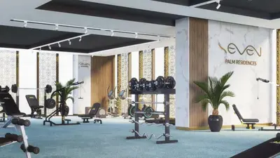 a gym with rows of exercise equipment and plants at VayK - Contemporary Studio with Beach Access on Palm Jumeirah in Dubai