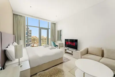 a bedroom with a bed and a tv and a couch at VayK - Contemporary Studio with Beach Access on Palm Jumeirah in Dubai