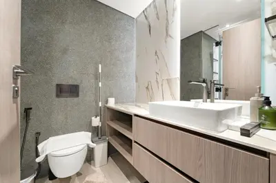 a bathroom with a sink and a toilet at VayK - Refined Studio in Dubai Hills with Pool View in Dubai