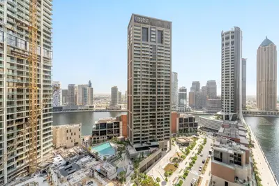 a view of a city with a river and buildings at VayK - Sunlit Studio with Canal Views in Business Bay in Dubai