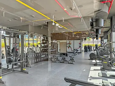 a gym with rows of treadmills and machines at VayK - Sunlit Studio with Canal Views in Business Bay in Dubai