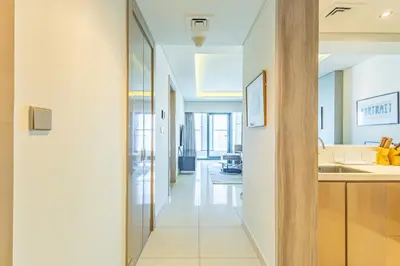 a hallway leading to a kitchen and a living room at Superhost - 1BR , Pool & Gym , DAMAC Towers Paramount in Dubai