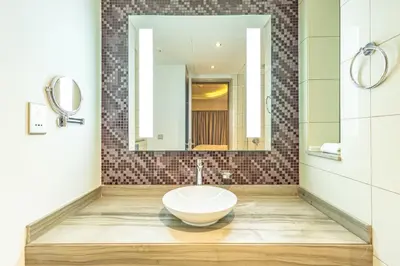 a bathroom with a sink and a mirror at Superhost - 1BR , Pool & Gym , DAMAC Towers Paramount in Dubai
