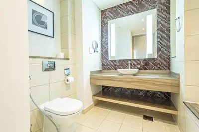 a bathroom with a sink and a toilet at Superhost - 1BR , Pool & Gym , DAMAC Towers Paramount in Dubai