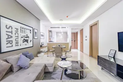 a living room with a couch and a table at Superhost - 1BR , Pool & Gym , DAMAC Towers Paramount in Dubai