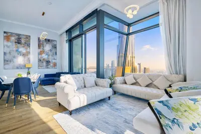 a living room with white furniture and a large window at Signature Luxury Apartments Downtown Dubai in Dubai