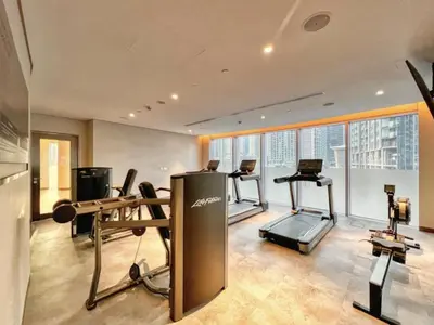 a gym with treadmills and exercise equipment in a building at Prime Downtown Luxury Stays by Burj Khalifa in Dubai