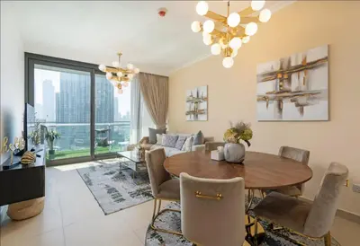 a living room with a table and a couch at Prime Downtown Luxury Stays by Burj Khalifa in Dubai
