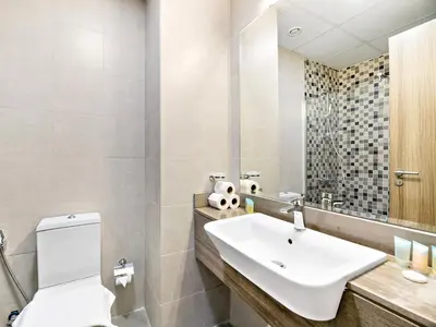 a bathroom with a sink and a toilet at Trendy Luxe Studio In Al Furjan close to Metro-17 in Dubai