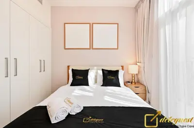 a white bedroom with a large bed with towels on it at Contemporary 3-Bedroom Villa by Deleguest in Dubai
