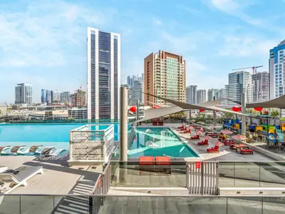 a pool on the roof of a building with a city at Cozy Studio with Balcony I Near Dubai Mall & Downtown in Dubai