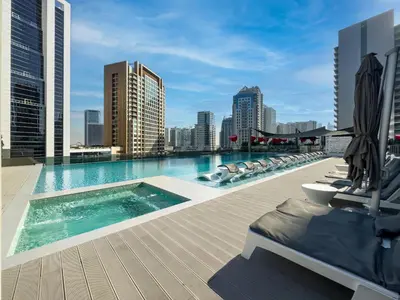 a swimming pool on the roof of a building at Cozy Studio with Balcony I Near Dubai Mall & Downtown in Dubai