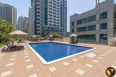 a swimming pool on the roof of a building with tall buildings at Vogue Marina Diamond Near JBR Beach and Marina Mall, Two Bedroom Apartment with Balcony and City View, Access to all Amenities, Walkable to Sobha Realty Metro Station and Bus Stop in Dubai