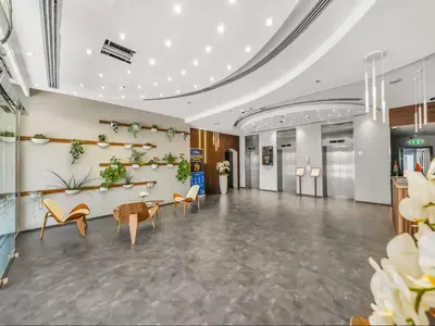 a lobby with chairs and a table in a building at Vogue Marina Diamond Near JBR Beach and Marina Mall, Two Bedroom Apartment with Balcony and City View, Access to all Amenities, Walkable to Sobha Realty Metro Station and Bus Stop in Dubai
