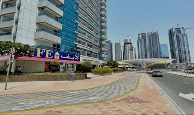 a street in a city with tall buildings at Vogue Marina Diamond Near JBR Beach and Marina Mall, Two Bedroom Apartment with Balcony and City View, Access to all Amenities, Walkable to Sobha Realty Metro Station and Bus Stop in Dubai