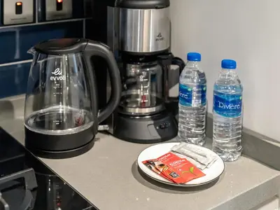 a counter with a blender and two bottles of water at Spacious Studio with Balcony I Near Dubai Mall & Downtown in Dubai