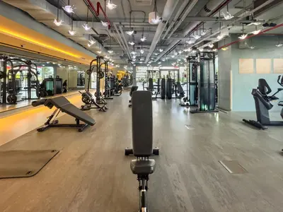 a gym with treadmills and exercise equipment in a room at Spacious Studio with Balcony I Near Dubai Mall & Downtown in Dubai
