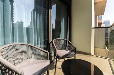 a balcony with two chairs and a table at Chic Downtown Act Tower Walk to Burj Khalifa&Mall in Dubai