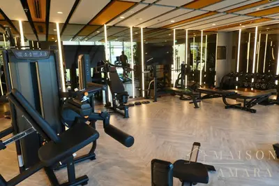 a gym with a bunch of treadmills and machines at Modern Luxury Studio Damac Hills With Golf View in Dubai