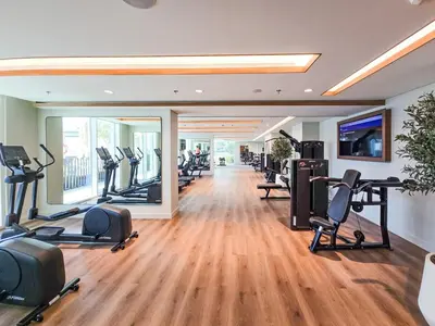 a gym with treadmills and cardio equipment in a building at Exquisite Beachfront 1BR l Palace Beach Residence in Dubai