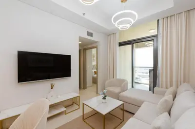 a living room with white furniture and a flat screen tv at Aykon City Tower C, Business Bay - Onelink in Dubai