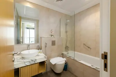 a bathroom with a sink and a toilet and a tub at Aykon City Tower C, Business Bay - Onelink in Dubai