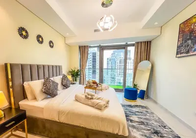 a bedroom with a bed and a large window at Iconic Burj Khalifa View 2BR Luxury apmt at Paramount Midtown in Dubai