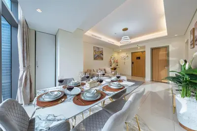 a dining room with a long table and chairs at Iconic Burj Khalifa View 2BR Luxury apmt at Paramount Midtown in Dubai