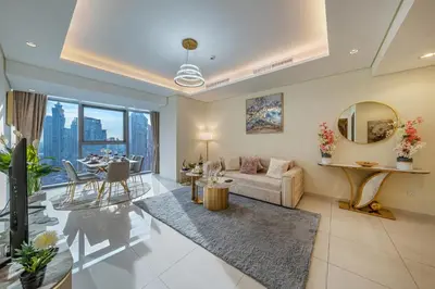 a living room with a couch and a table at Iconic Burj Khalifa View 2BR Luxury apmt at Paramount Midtown in Dubai