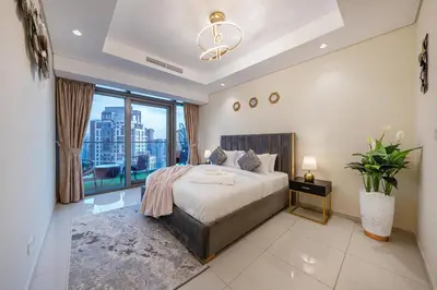 a bedroom with a large bed and a large window at Iconic Burj Khalifa View 2BR Luxury apmt at Paramount Midtown in Dubai
