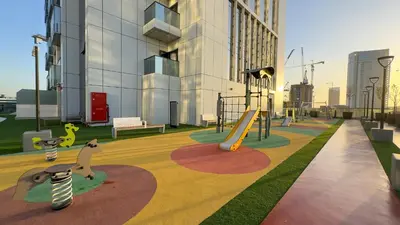 a playground with a slide in a building at Werova - Modern 1BR Apartment Prime JVT Location in Dubai