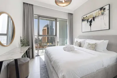 a bedroom with a large white bed and a large window at Exclusive Apartments in Burj Vista Downtown Dubai Near Burj Khalifa in Dubai