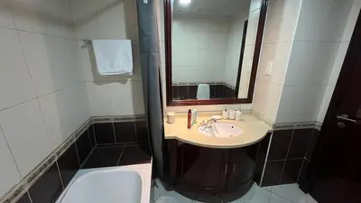 a bathroom with a sink and a mirror at Dubai Marina Apartment Steps to DMCC Metro & JBR in Dubai
