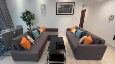a living room with two couches with pillows at Dubai Marina Apartment Steps to DMCC Metro & JBR in Dubai
