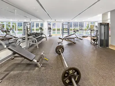 a gym with a lot of treadmills and machines at Reva Residence Comfort Suite 1BDR Plus Sofa Bed in Dubai