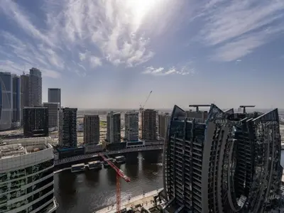 a view of a city with a river and buildings at Reva Residence Comfort Suite 1BDR Plus Sofa Bed in Dubai