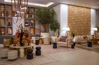 a lobby with couches and chairs and a chandelier at Prime Location with Direct Mall and Marina Walk Access, Just Outside DMCC Metro Station - VIDA Residences, Dubai Marina by Deluxe Holiday Homes in Dubai