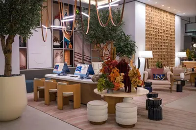 a lobby with a table and chairs and plants at Prime Location with Direct Mall and Marina Walk Access, Just Outside DMCC Metro Station - VIDA Residences, Dubai Marina by Deluxe Holiday Homes in Dubai