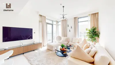 a living room with a couch and a tv at Stunning 2BR Beachfront Living Marina Vista Tower 2 in Dubai