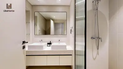 a bathroom with a sink and a shower at Stunning 2BR Beachfront Living Marina Vista Tower 2 in Dubai