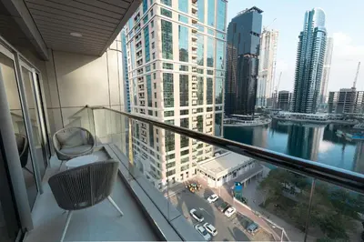 a balcony with a view of a city at Escape 24 Spacious 1BR Lake View, Global Lake View, JLT in Dubai