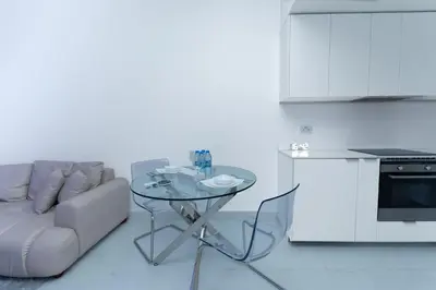 a living room with a table and a couch at Escape 24 Spacious 1BR Lake View, Global Lake View, JLT in Dubai