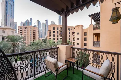 a balcony with chairs and a view of the city at Contemporary one-bedroom apartment in Burj Khalifa area by Norbu Holiday Homes in Dubai