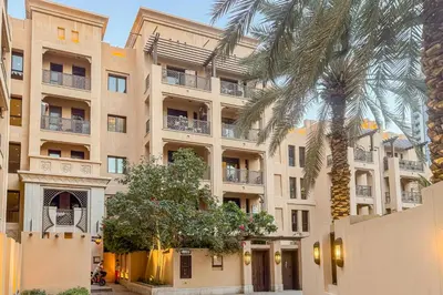 a palm tree in front of a building at Contemporary one-bedroom apartment in Burj Khalifa area by Norbu Holiday Homes in Dubai