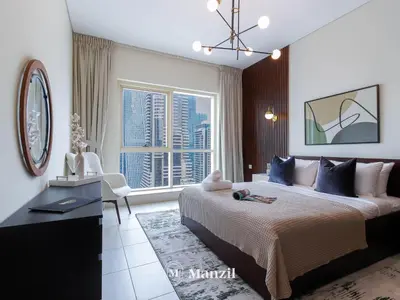 a bedroom with a large bed and a large window at Sea View 2BR in Dubai Marina near Dubai Eye in Dubai